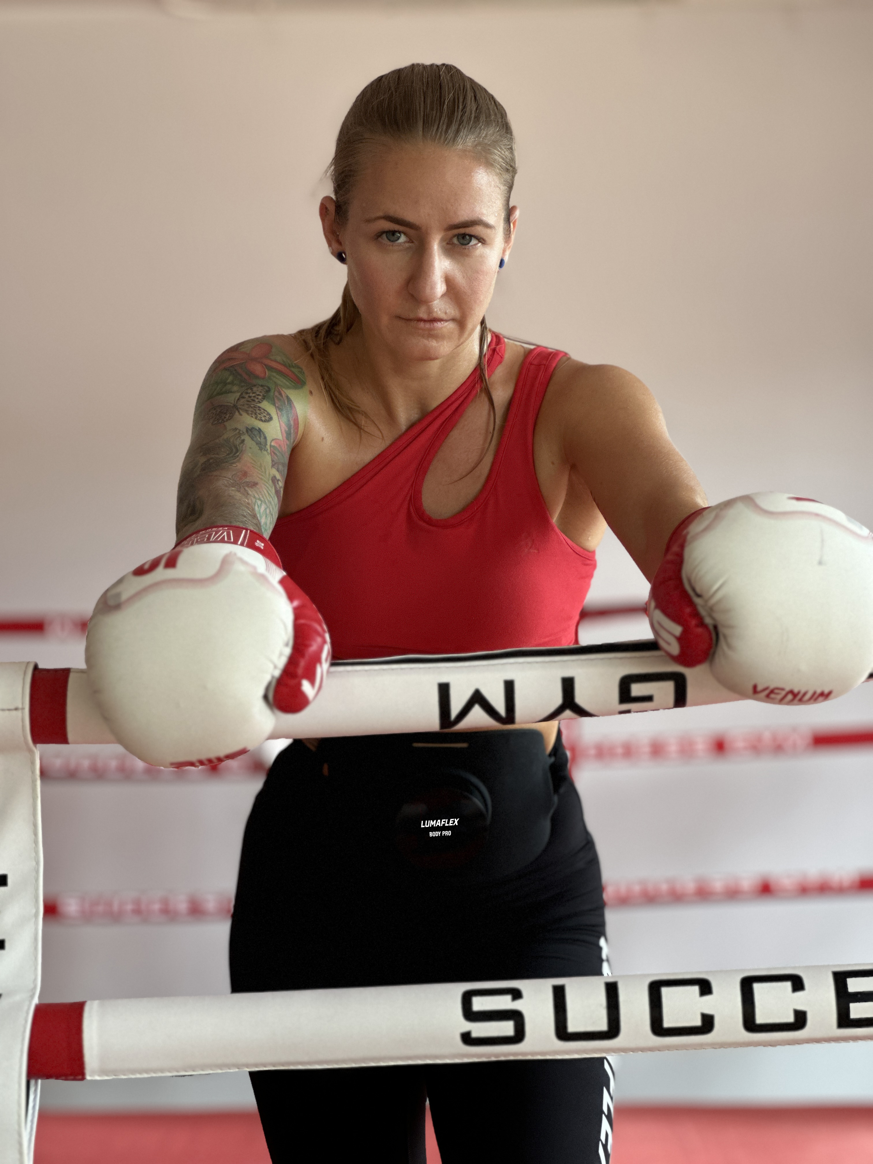 Boxer in ring with gloves up — combat-sport recovery and concussion protocols